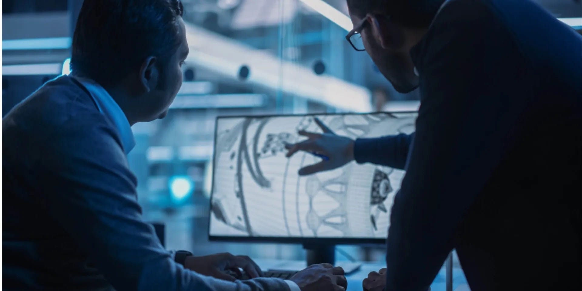 Two engineers study aircraft drawing on computer.